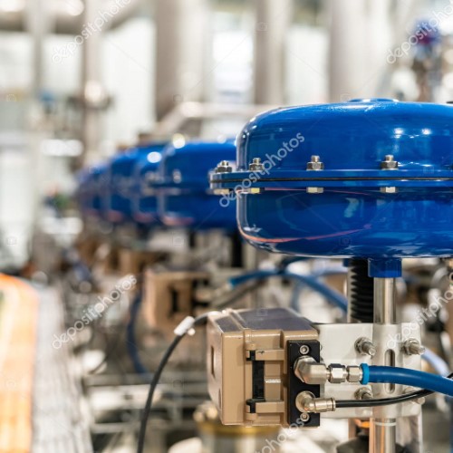 pneumatic valves in a row in a large industrial plant